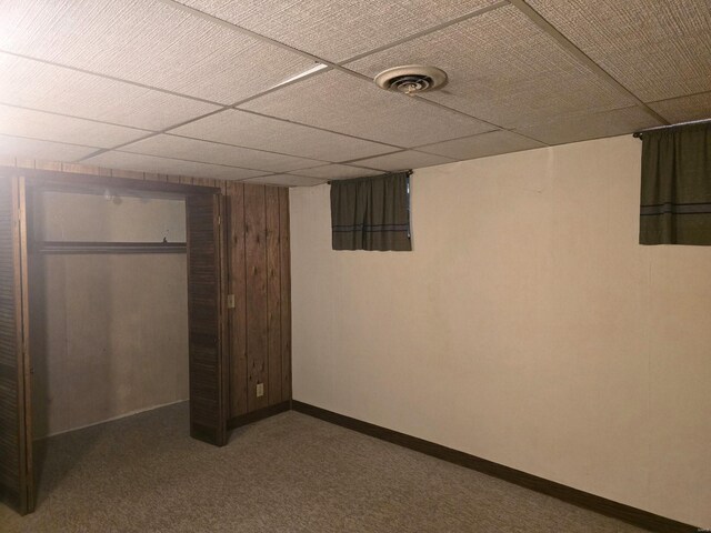 interior space with a drop ceiling, a closet, and carpet flooring