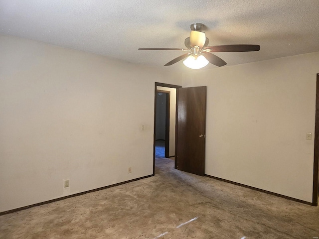 unfurnished room featuring a textured ceiling, light colored carpet, and ceiling fan