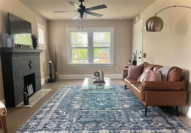 living room featuring a brick fireplace and ceiling fan