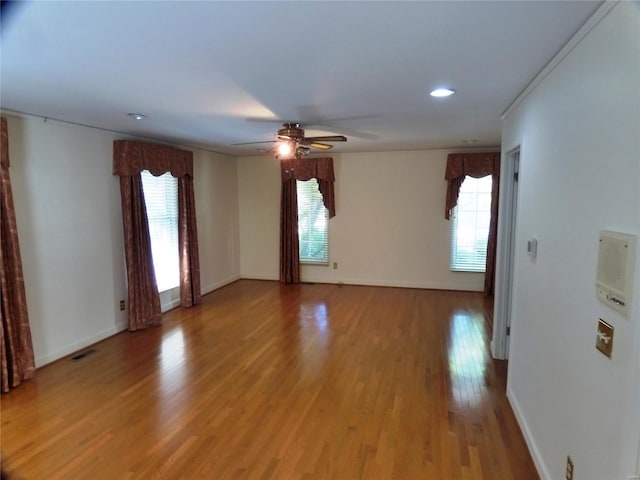 spare room with crown molding, ceiling fan, and hardwood / wood-style floors