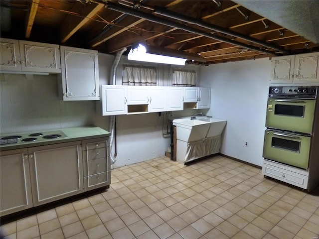 kitchen featuring gray cabinets, white electric cooktop, light tile patterned floors, and double wall oven