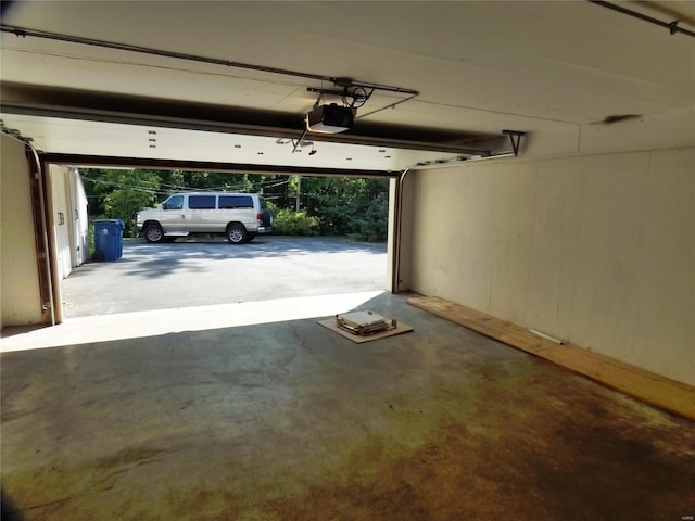 garage with a garage door opener and a carport