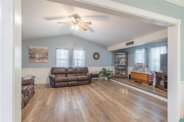 living room with ceiling fan, lofted ceiling, and light wood-type flooring