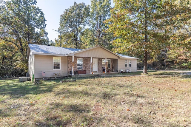 ranch-style home with a porch and a front lawn