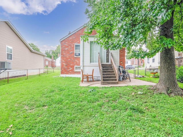 back of property featuring a patio and a yard