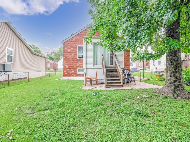 back of property featuring a yard and a patio area