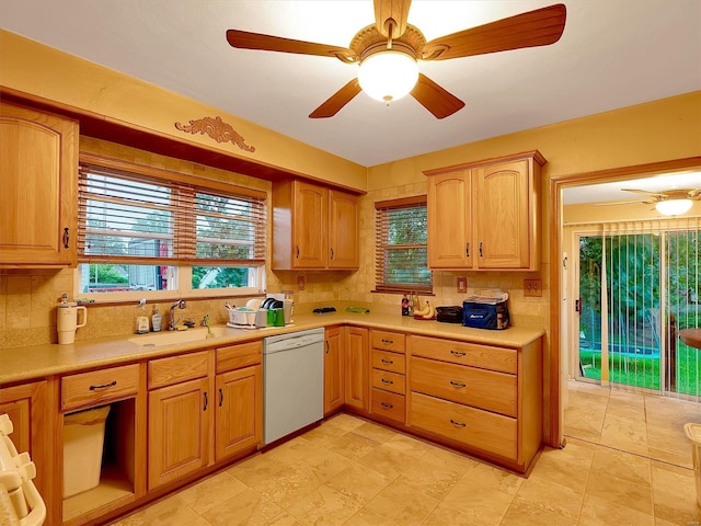 kitchen with light tile patterned flooring, dishwasher, ceiling fan, decorative backsplash, and sink