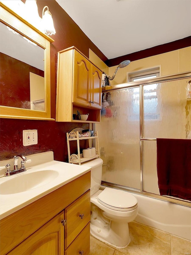 full bathroom with vanity, combined bath / shower with glass door, toilet, and tile patterned flooring