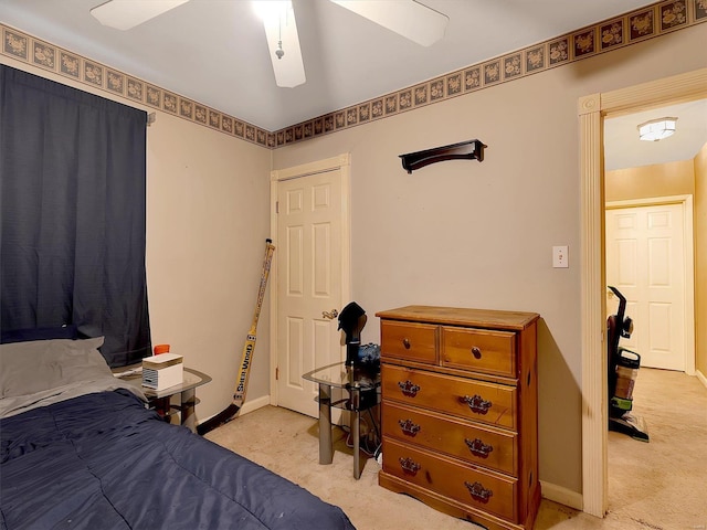 bedroom featuring ceiling fan and light colored carpet