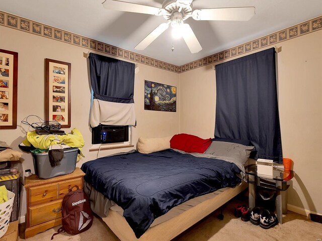 carpeted bedroom featuring cooling unit and ceiling fan