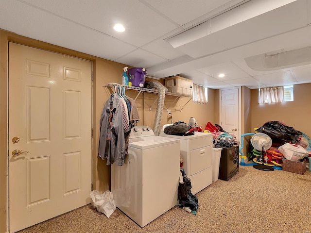 laundry area featuring washing machine and clothes dryer and carpet