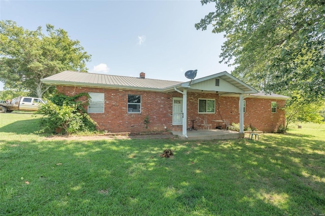 rear view of house with a yard