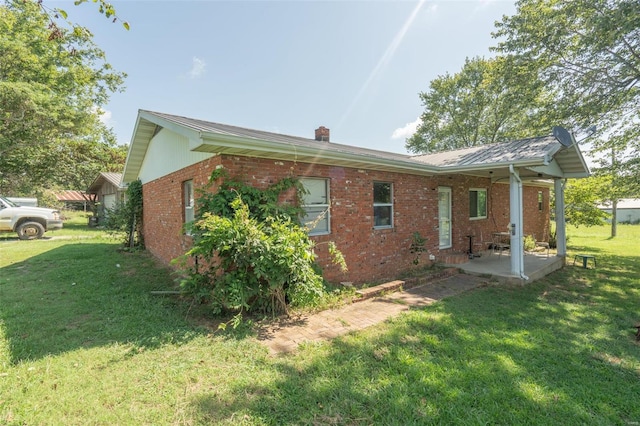 view of property exterior featuring a patio and a yard