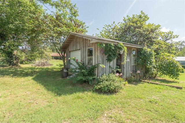 view of outbuilding featuring a garage and a yard