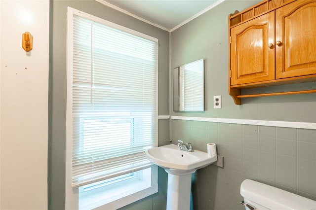 bathroom featuring tile walls and toilet