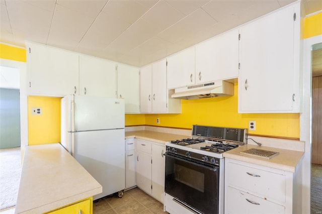 kitchen with white appliances, white cabinetry, and light tile patterned floors