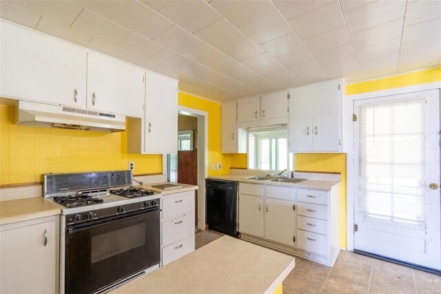 kitchen with white range with gas stovetop, sink, dishwasher, light tile patterned floors, and white cabinets