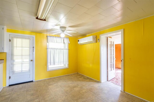 tiled empty room with ceiling fan and a wall unit AC