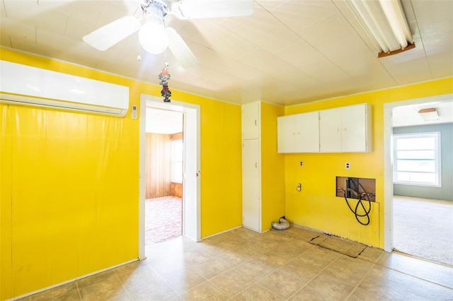 clothes washing area featuring washer hookup, ceiling fan, and a wall unit AC