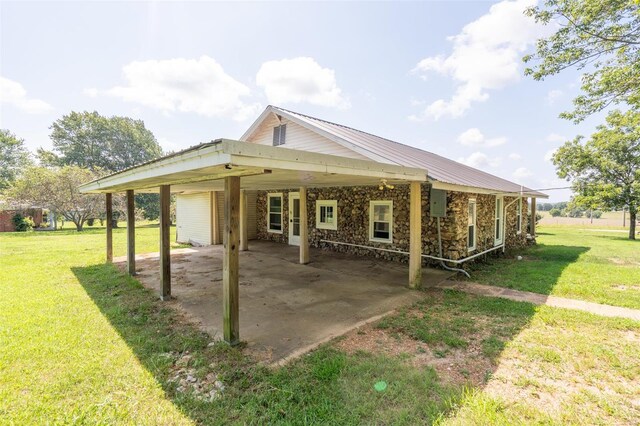 back of house with a patio area and a yard