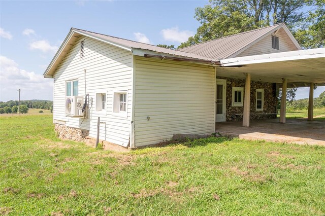 exterior space featuring a carport and a yard