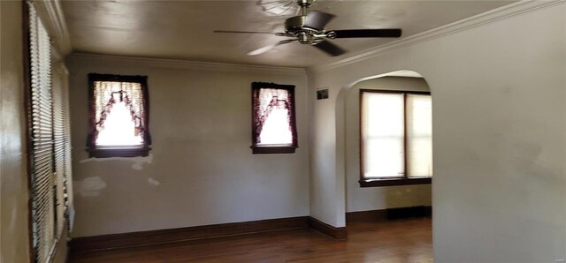 spare room with ceiling fan, hardwood / wood-style floors, and crown molding