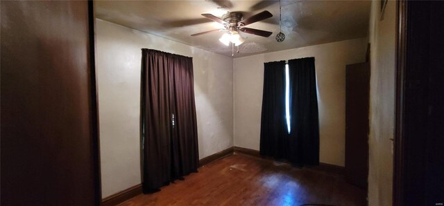 spare room with hardwood / wood-style flooring and ceiling fan