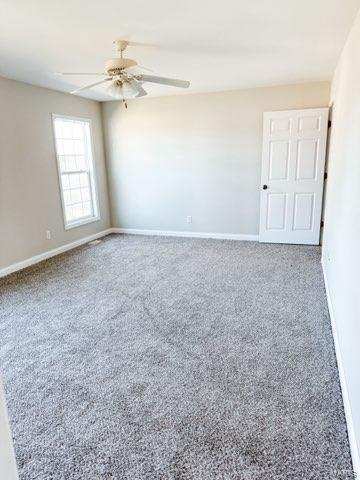 empty room featuring carpet and ceiling fan