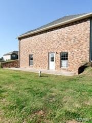 rear view of property featuring a lawn