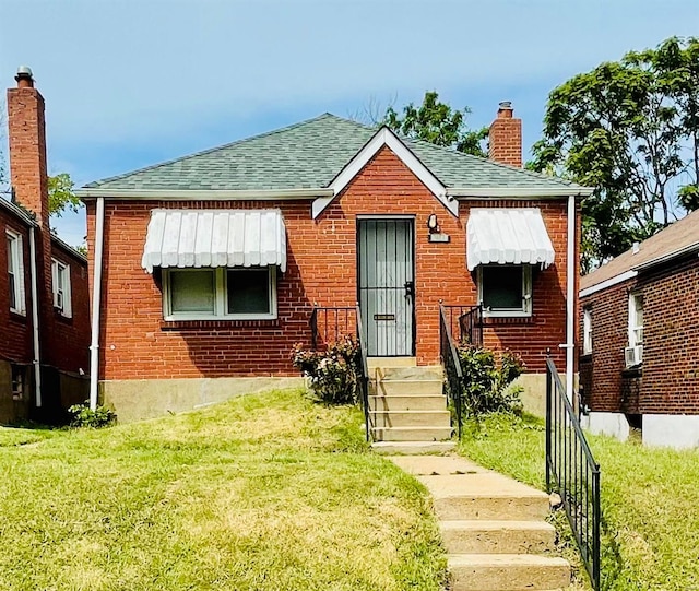 bungalow-style house with a front lawn and cooling unit