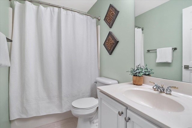 bathroom featuring vanity, tile patterned floors, and toilet