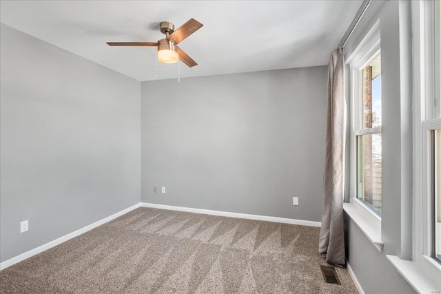 empty room with ceiling fan and carpet flooring