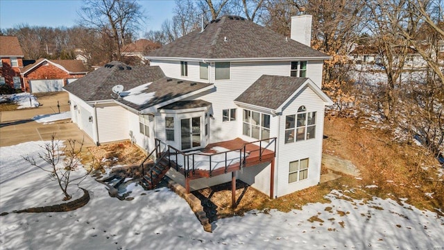 view of snow covered rear of property