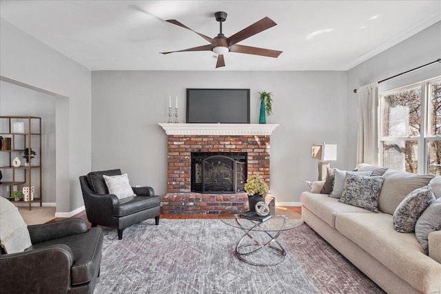 living room with a fireplace and ceiling fan