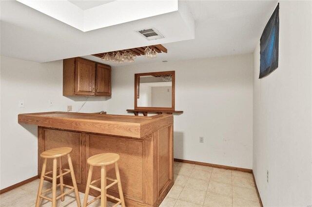 kitchen featuring a kitchen bar and kitchen peninsula