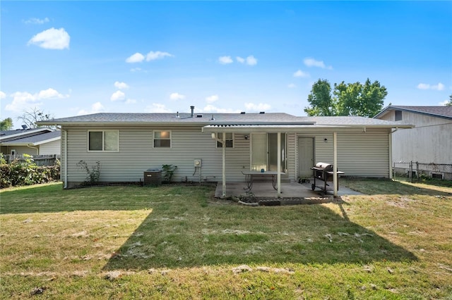 rear view of house with a yard and a patio area