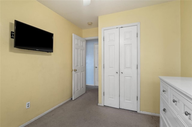 unfurnished bedroom with light carpet and a closet