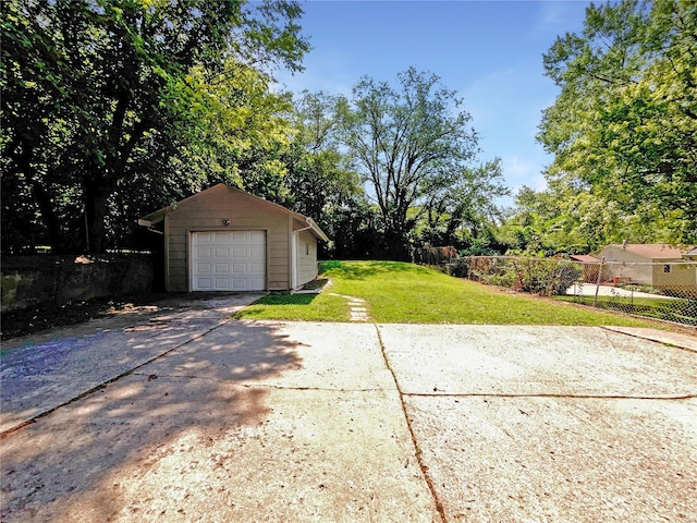 view of yard featuring a garage and an outbuilding