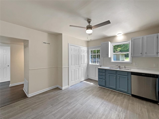 kitchen with ceiling fan, sink, dishwasher, and light hardwood / wood-style floors