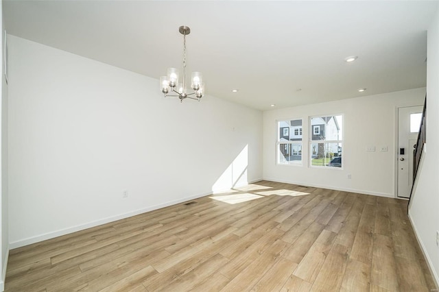 interior space with light wood-type flooring and an inviting chandelier