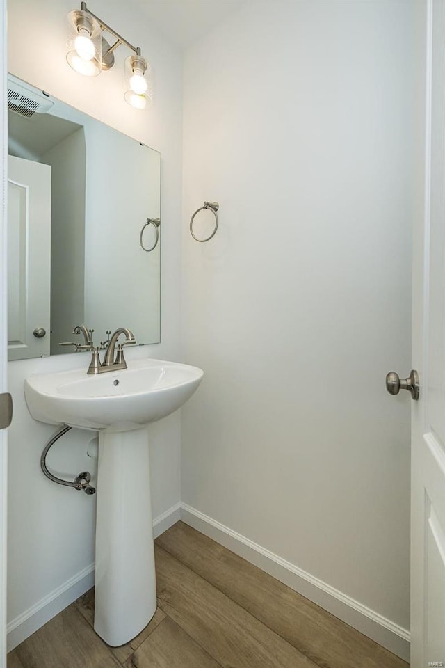 bathroom with wood-type flooring