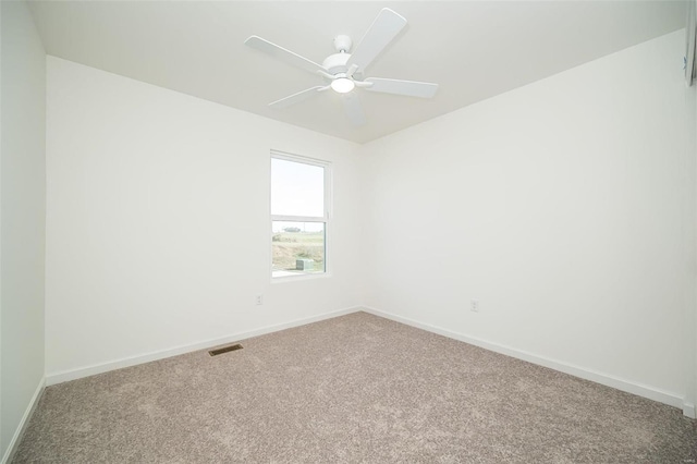 carpeted spare room with ceiling fan