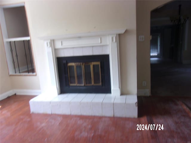 details featuring a wall mounted air conditioner, a fireplace, and hardwood / wood-style flooring