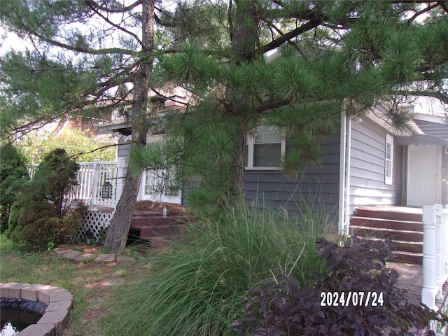 view of side of property featuring a wooden deck