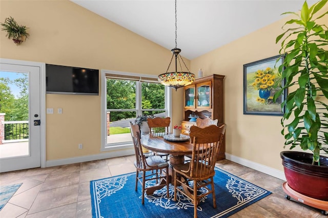 dining room with light tile patterned flooring and lofted ceiling