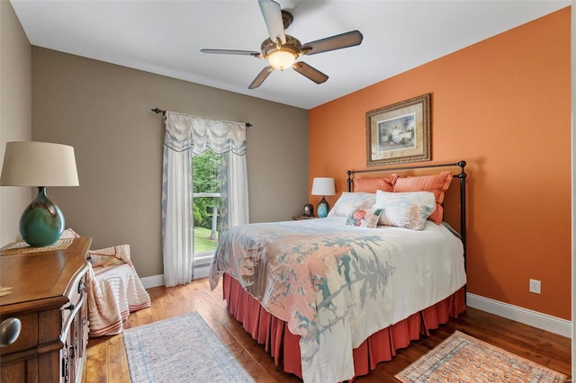 bedroom with ceiling fan and wood-type flooring