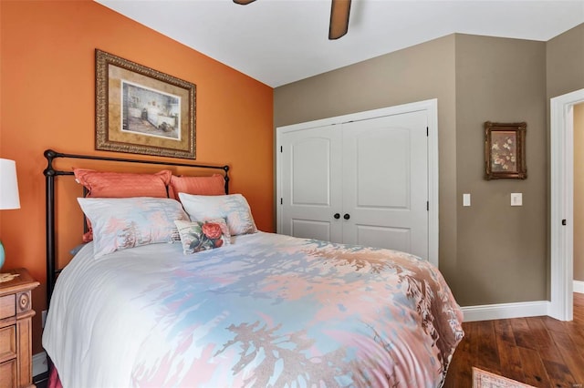 bedroom with dark hardwood / wood-style floors, a closet, and ceiling fan