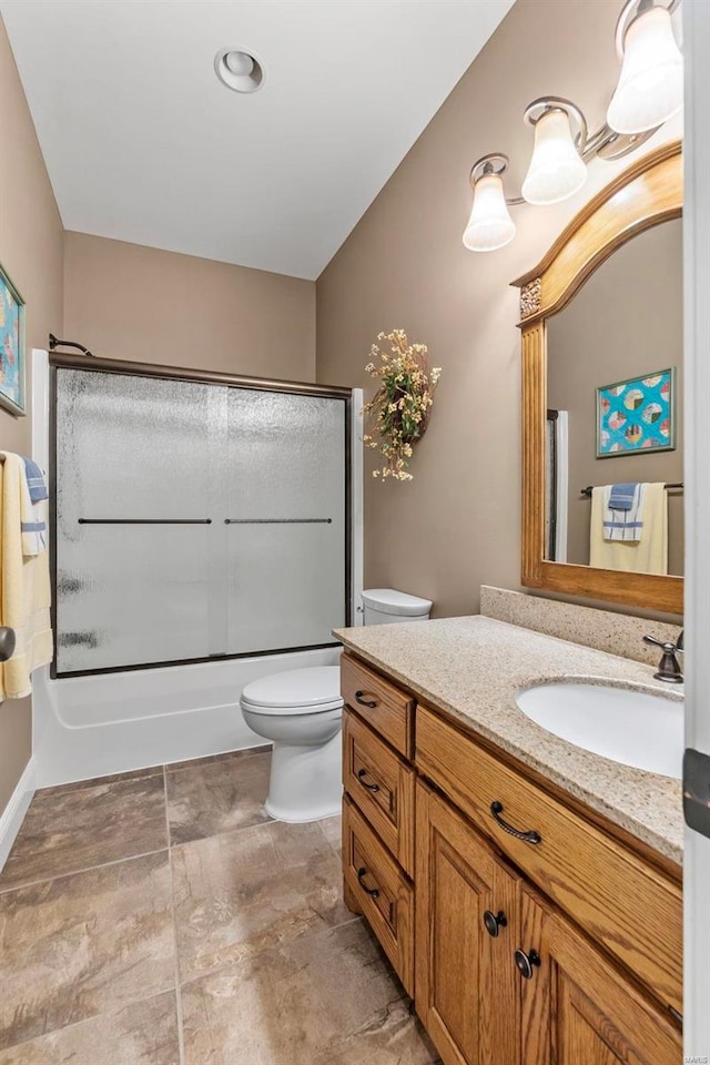 full bathroom with shower / bath combination with glass door, vanity, tile patterned floors, and toilet