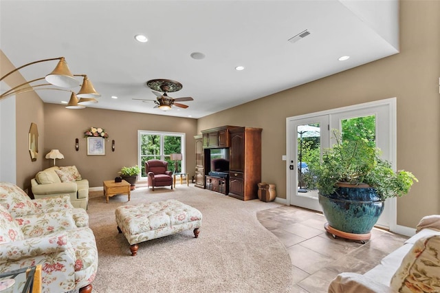 living room with light tile patterned floors and ceiling fan