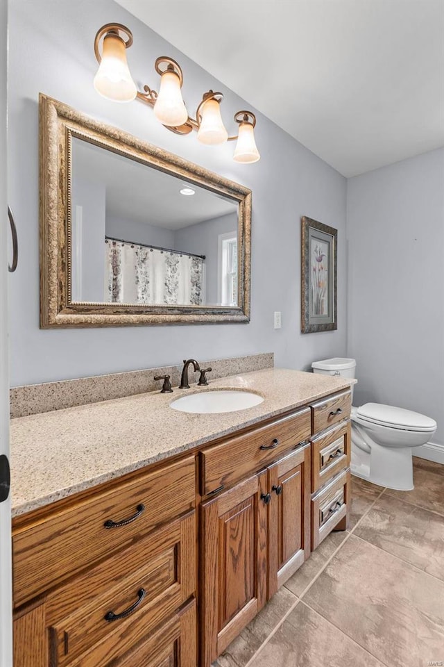 bathroom with vanity, toilet, and tile patterned floors